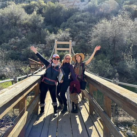 Three DEQ staff pose on a bridge